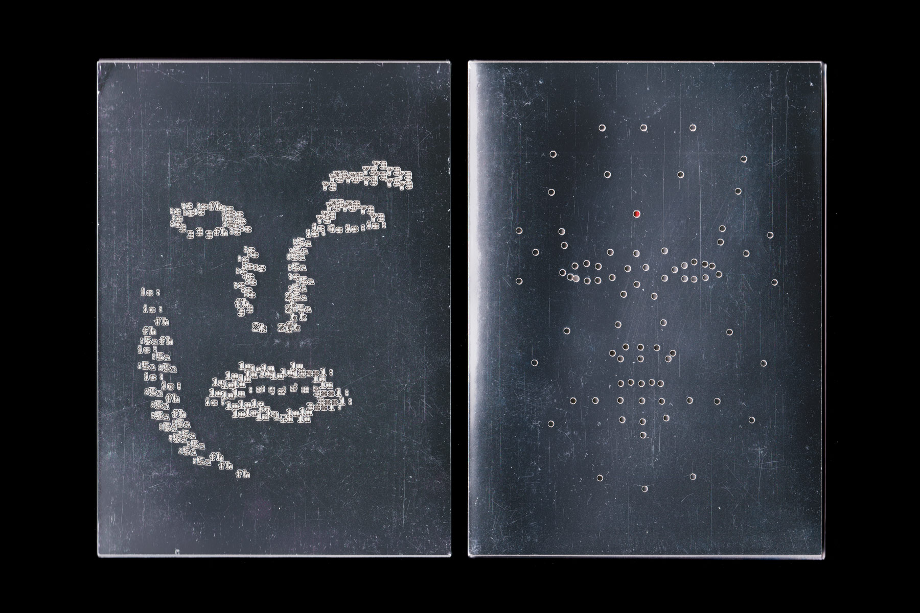 Metallic front and back covers with laser cut figures resembling a face on each cover.