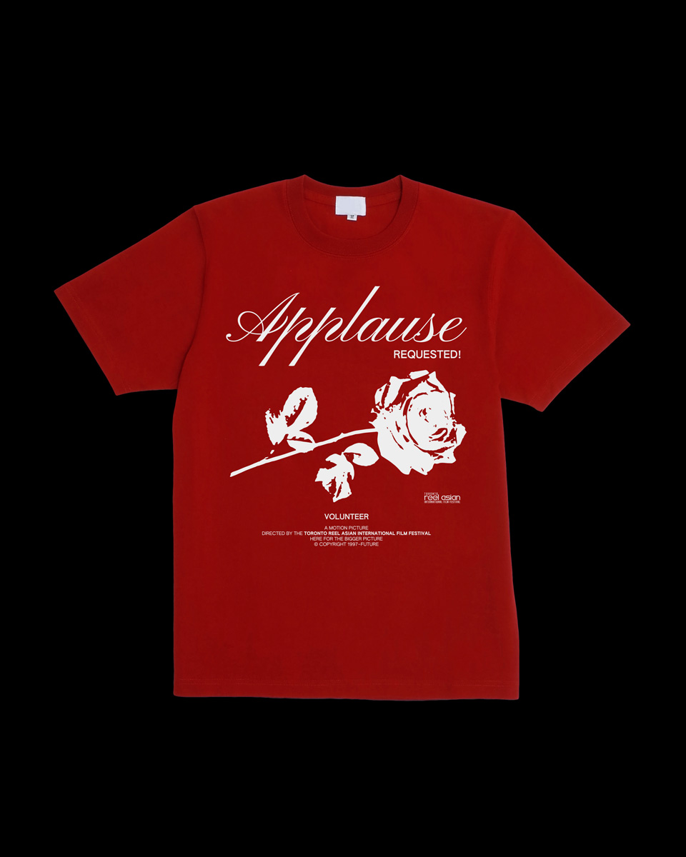 A red t-shirt that reads 'Applause Requested!' along with a depiction of a rose, both printed in white.